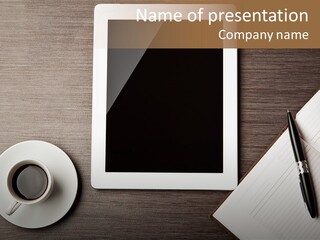 A Tablet Computer Sitting On Top Of A Desk Next To A Cup Of Coffee PowerPoint Template