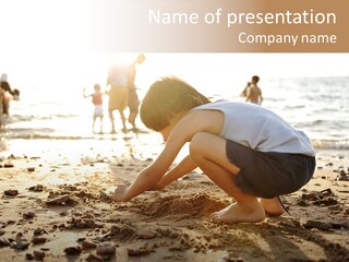 A Young Boy Playing In The Sand At The Beach PowerPoint Template