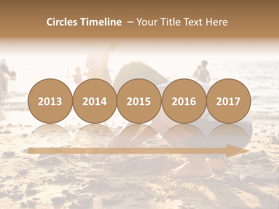 A Young Boy Playing In The Sand At The Beach PowerPoint Template