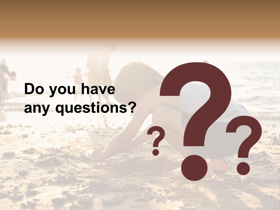 A Young Boy Playing In The Sand At The Beach PowerPoint Template