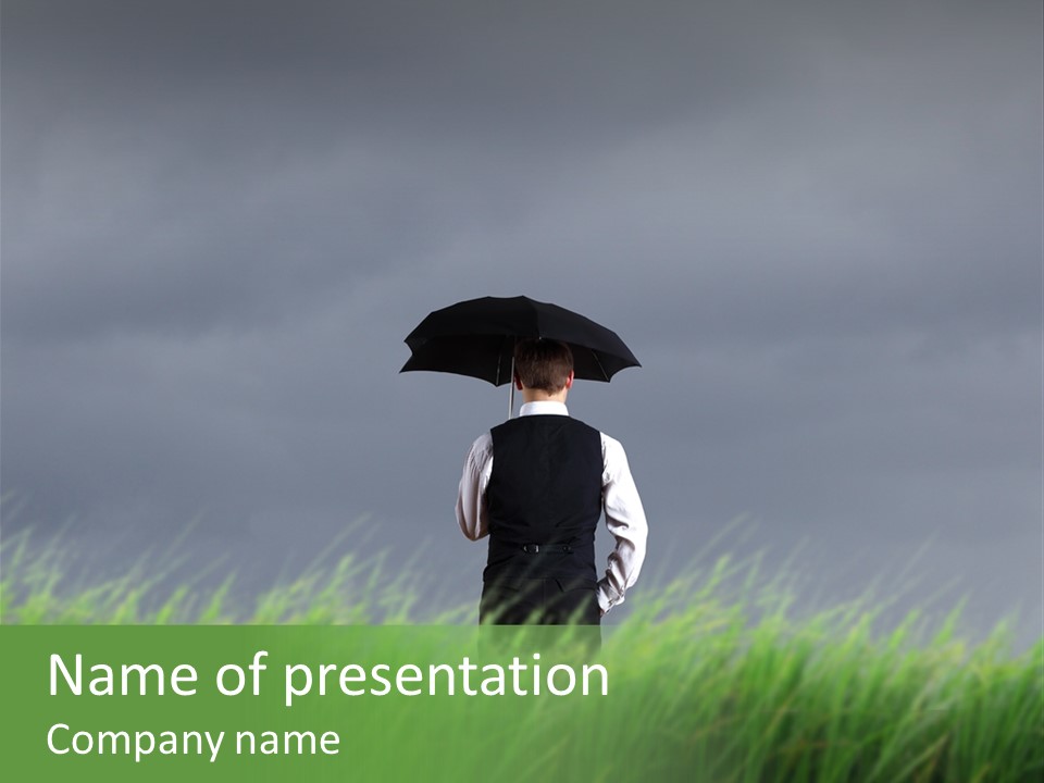 A Man Standing In A Field Holding An Umbrella PowerPoint Template