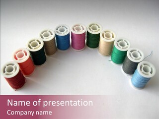 A Group Of Spools Of Thread On A White Surface PowerPoint Template