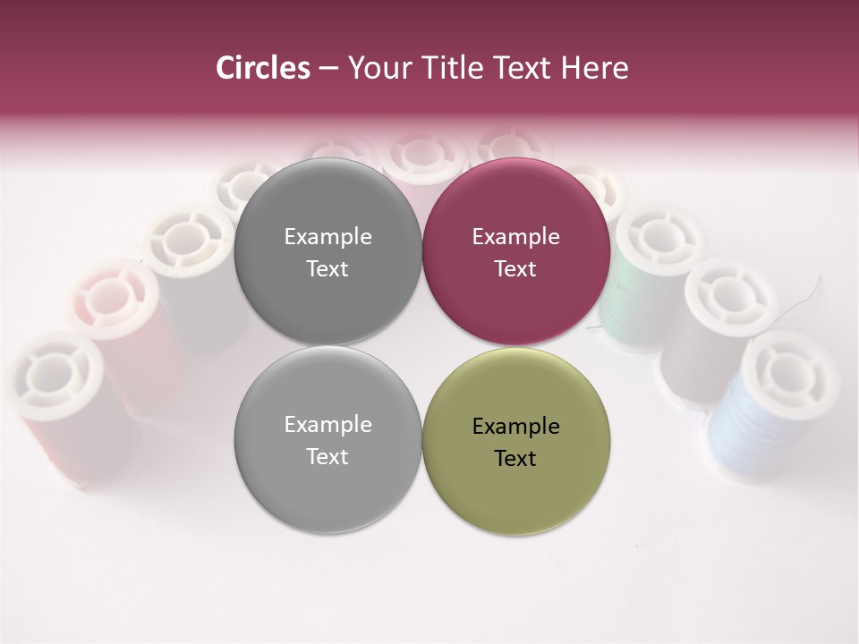 A Group Of Spools Of Thread On A White Surface PowerPoint Template