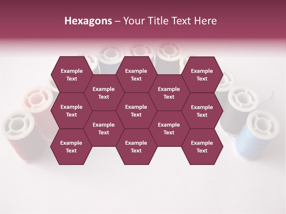 A Group Of Spools Of Thread On A White Surface PowerPoint Template
