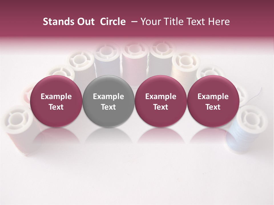 A Group Of Spools Of Thread On A White Surface PowerPoint Template