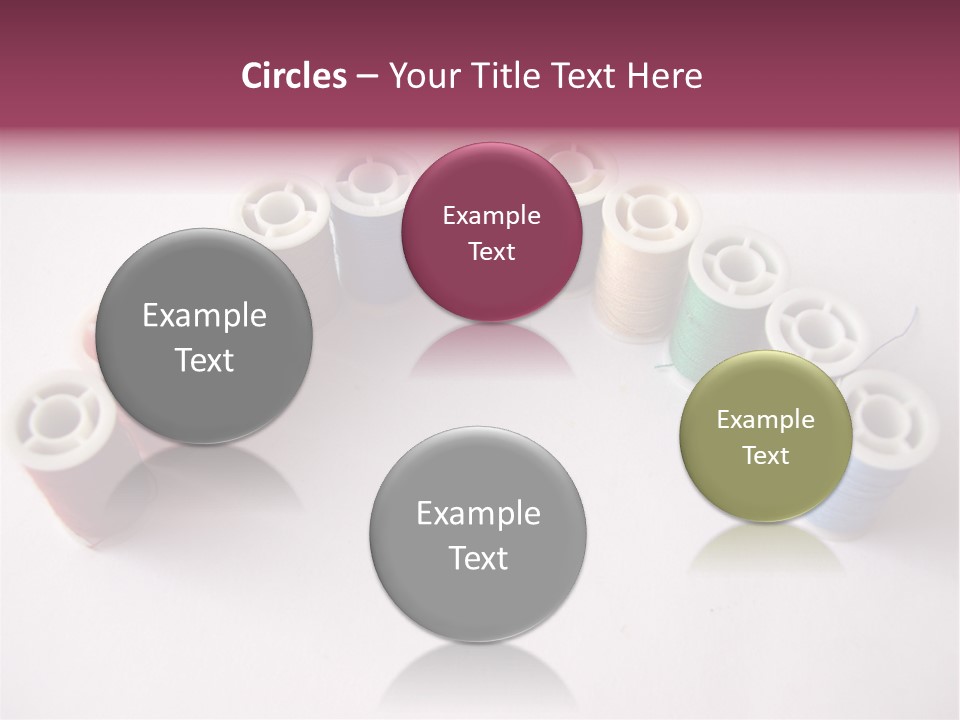A Group Of Spools Of Thread On A White Surface PowerPoint Template