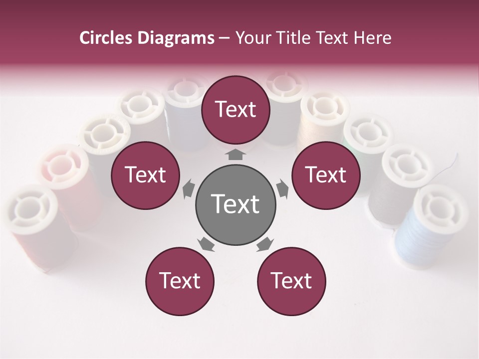 A Group Of Spools Of Thread On A White Surface PowerPoint Template