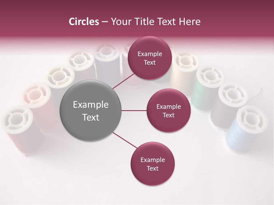 A Group Of Spools Of Thread On A White Surface PowerPoint Template