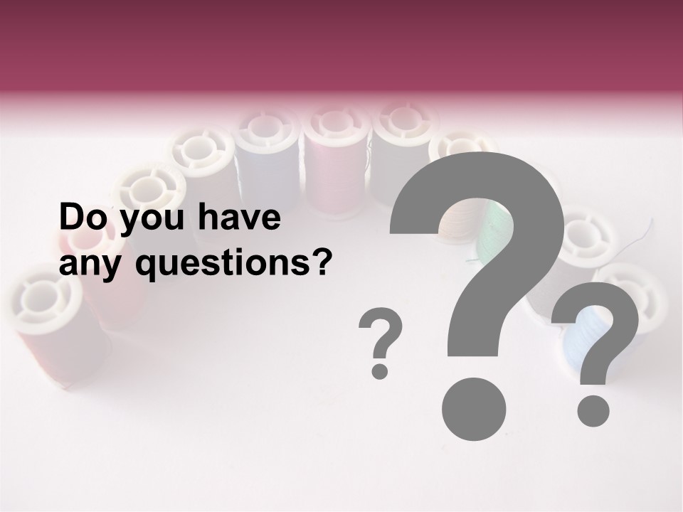 A Group Of Spools Of Thread On A White Surface PowerPoint Template