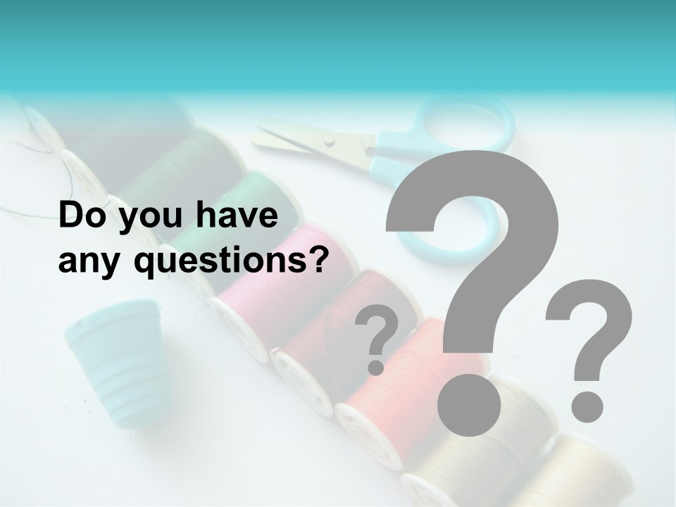 A Pair Of Scissors And Spools Of Thread On A Table PowerPoint Template