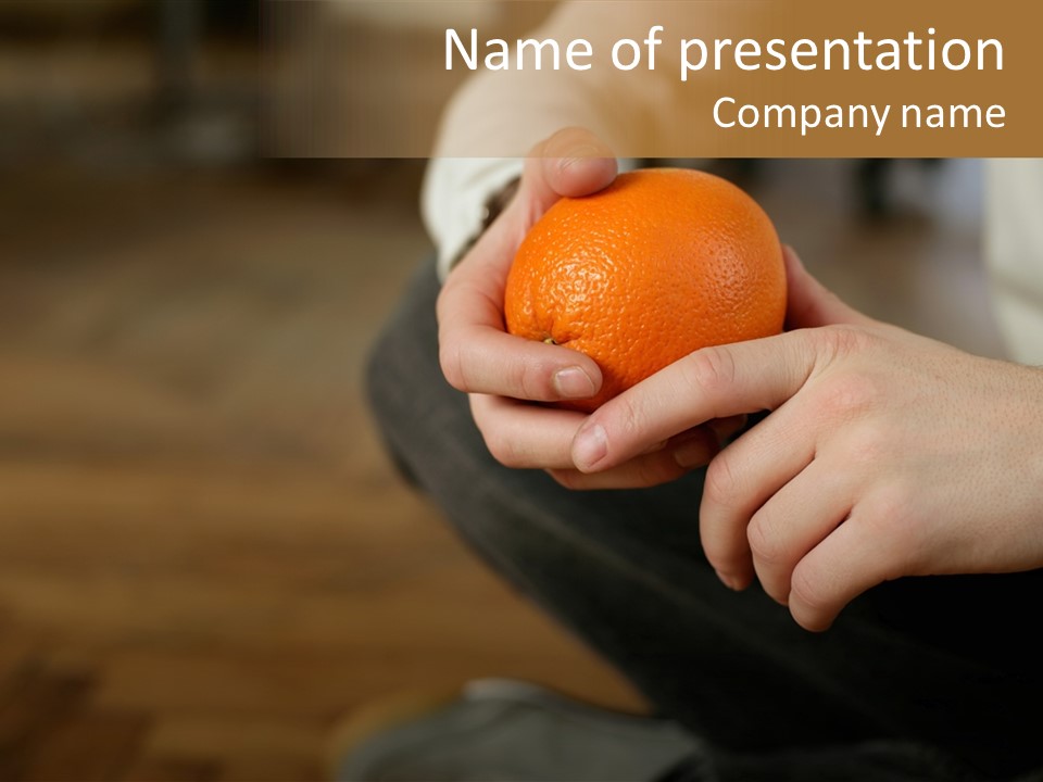 Man Sitting On Floor Holding An Orange PowerPoint Template