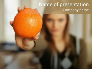 Woman Holding Out An Orange PowerPoint Template