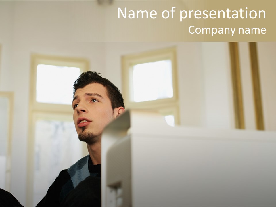 Man Sitting Behind A Computer PowerPoint Template