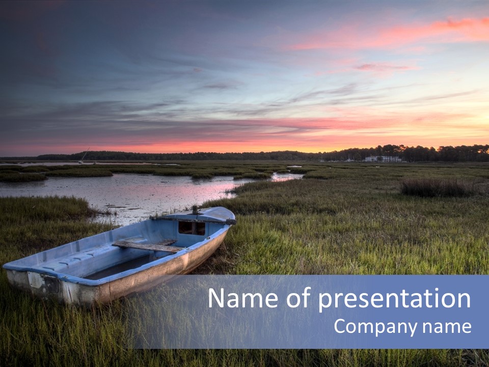 A Boat Sitting On Top Of A Lush Green Field PowerPoint Template