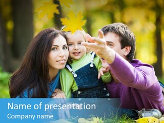 A Man And Woman Holding A Child In The Park PowerPoint Template