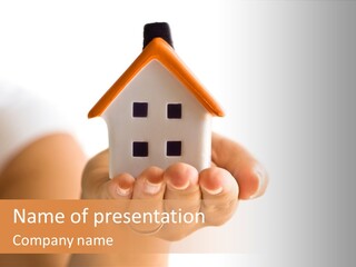 A Person Holding A Small House In Their Hands PowerPoint Template