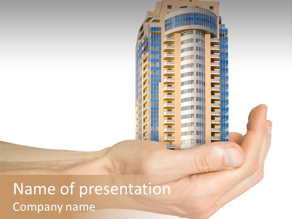 A Hand Holding A Model Of A Building PowerPoint Template