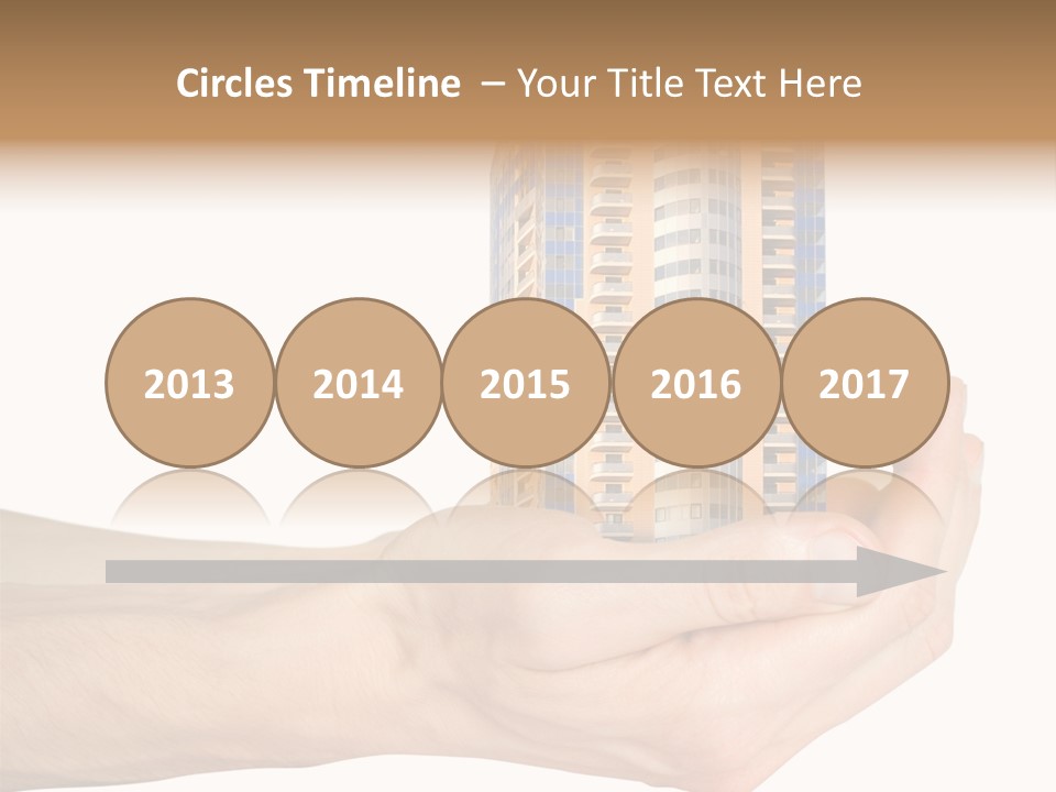 A Hand Holding A Model Of A Building PowerPoint Template