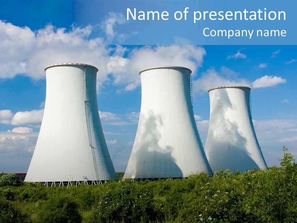 Three Cooling Towers In A Field With A Blue Sky In The Background PowerPoint Template
