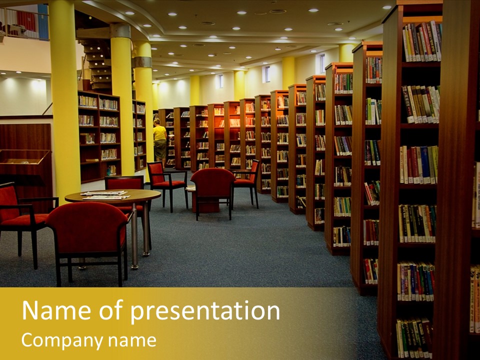 A Library Filled With Lots Of Books And Chairs PowerPoint Template