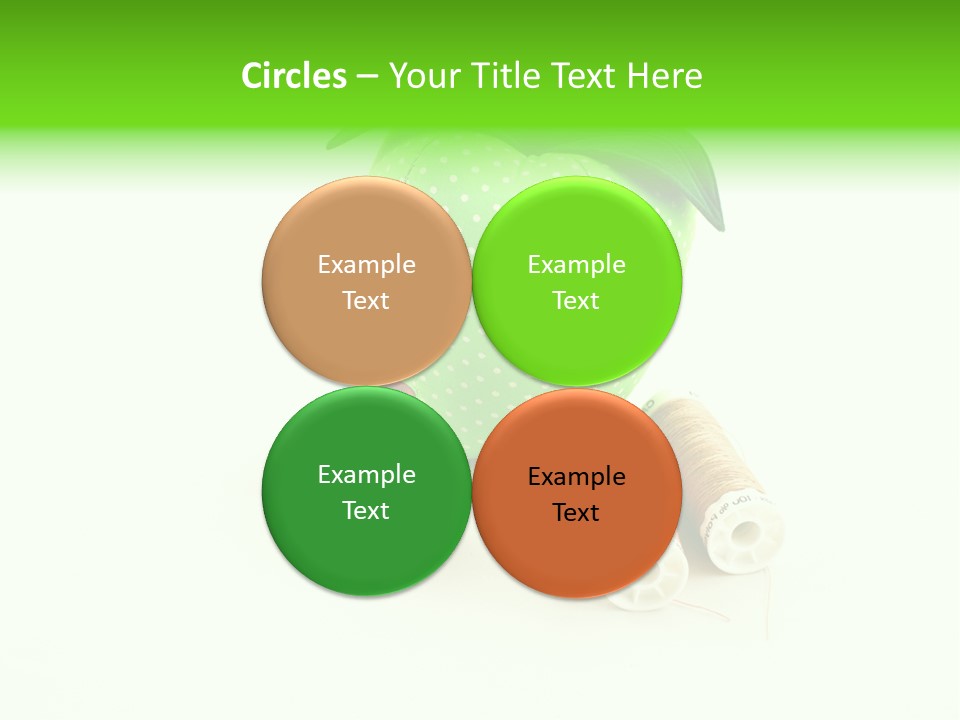 A Green Apple Sitting Next To Two Spools Of Thread PowerPoint Template