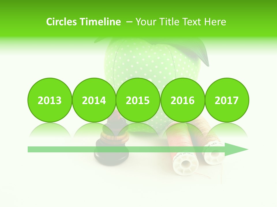 A Green Apple Sitting Next To Two Spools Of Thread PowerPoint Template