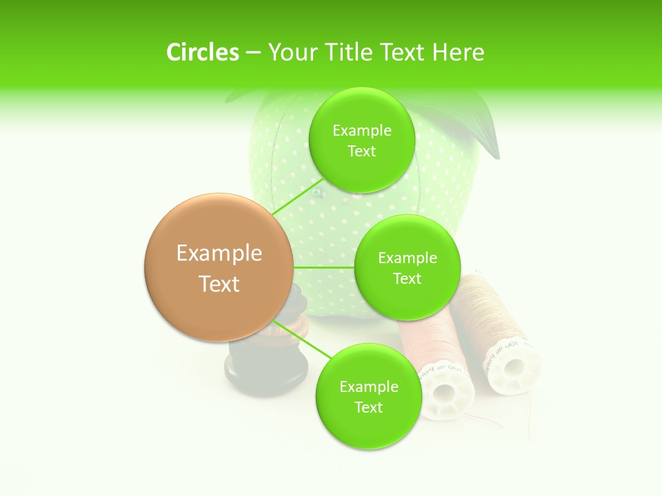 A Green Apple Sitting Next To Two Spools Of Thread PowerPoint Template