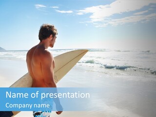 A Man Holding A Surfboard On A Beach PowerPoint Template