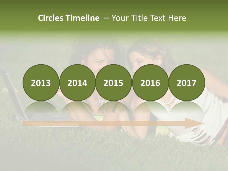 Two Women Laying In The Grass With A Laptop PowerPoint Template