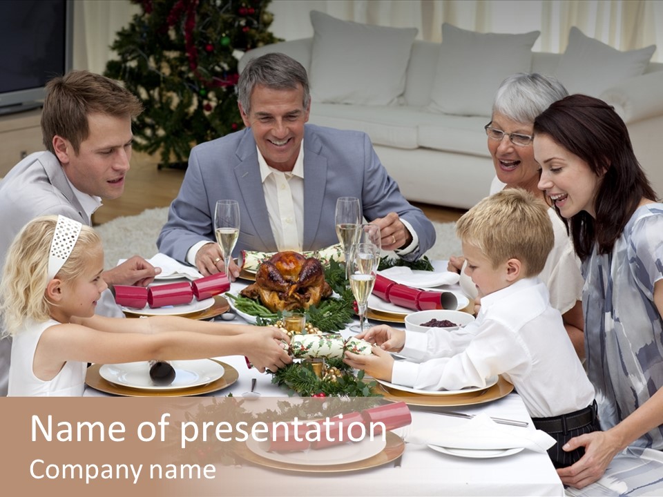 A Group Of People Sitting Around A Table With Food PowerPoint Template