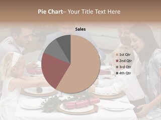 A Group Of People Sitting Around A Table With Food PowerPoint Template