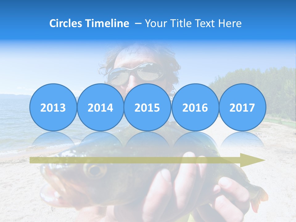 A Man Holding A Large Fish On A Beach PowerPoint Template