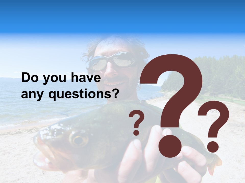 A Man Holding A Large Fish On A Beach PowerPoint Template