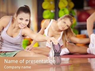 A Group Of Women Sitting On The Floor In A Gym PowerPoint Template