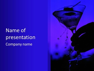 A Person Holding A Martini Glass In Their Hand PowerPoint Template