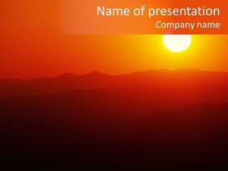 The Sun Is Setting Over A Mountain Range PowerPoint Template