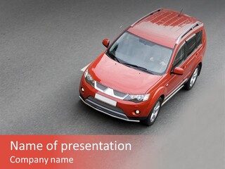A Red Car Is Driving Down The Road PowerPoint Template