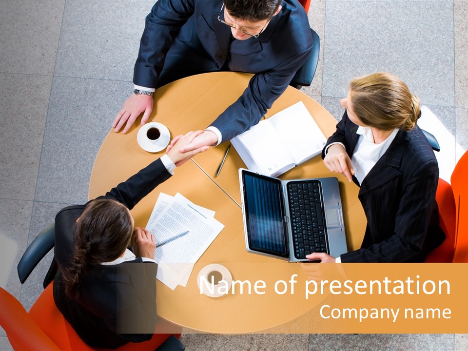 A Group Of People Sitting At A Table With Laptops PowerPoint Template