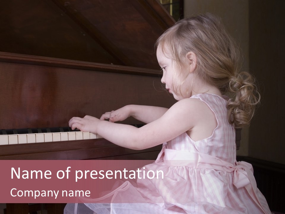 Three-Year Old Girl Sitting A A Piano. PowerPoint Template