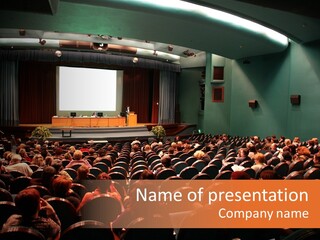 A Large Auditorium Filled With Lots Of People PowerPoint Template