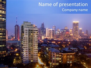 Skyline Of Business And Commercial District At Night PowerPoint Template