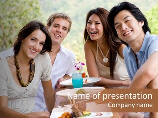 A Group Of Young Adults Having Lunch On Vacation PowerPoint Template