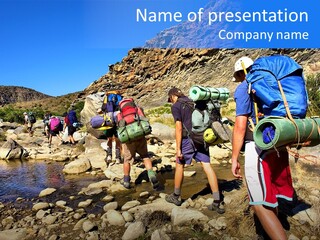 Group Of Hikers Crosses Small River In Mountains. Shot In The Langeberge Highlands Near Grootrivier And Gouritsrivier Rivers Crossing, Garden Route, Western Cape, South Africa. PowerPoint Template