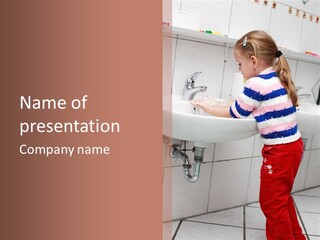 Small Girl Washing Her Hands In The Bathroom PowerPoint Template