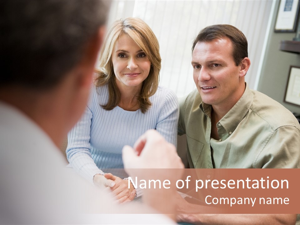 Couple In Consultation At Ivf Clinic Talking To Doctor PowerPoint Template