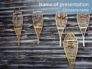 Old Snowshoes Nailed To The Side Of An Old Weathered Barn PowerPoint Template