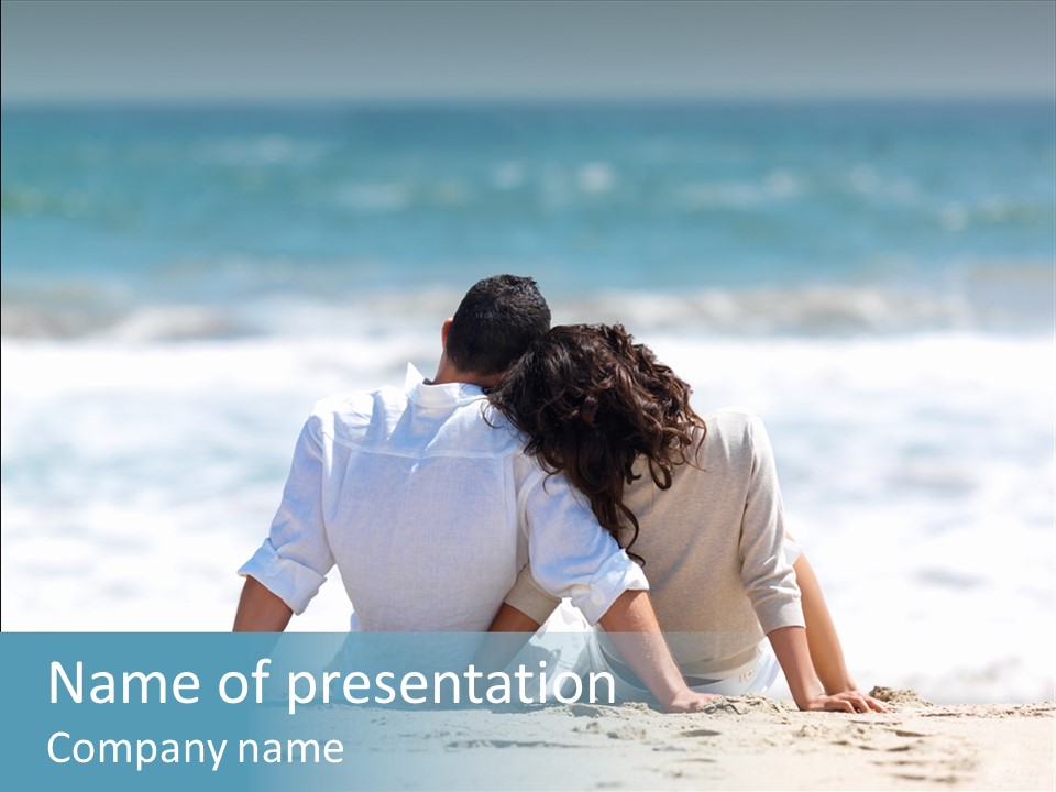 A Couple Sitting On The Beach Looking Out At The Ocean PowerPoint Template