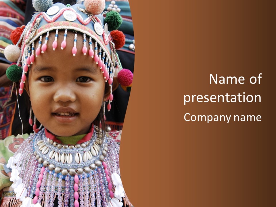 A Young Child Wearing A Headdress Is Smiling For The Camera PowerPoint Template
