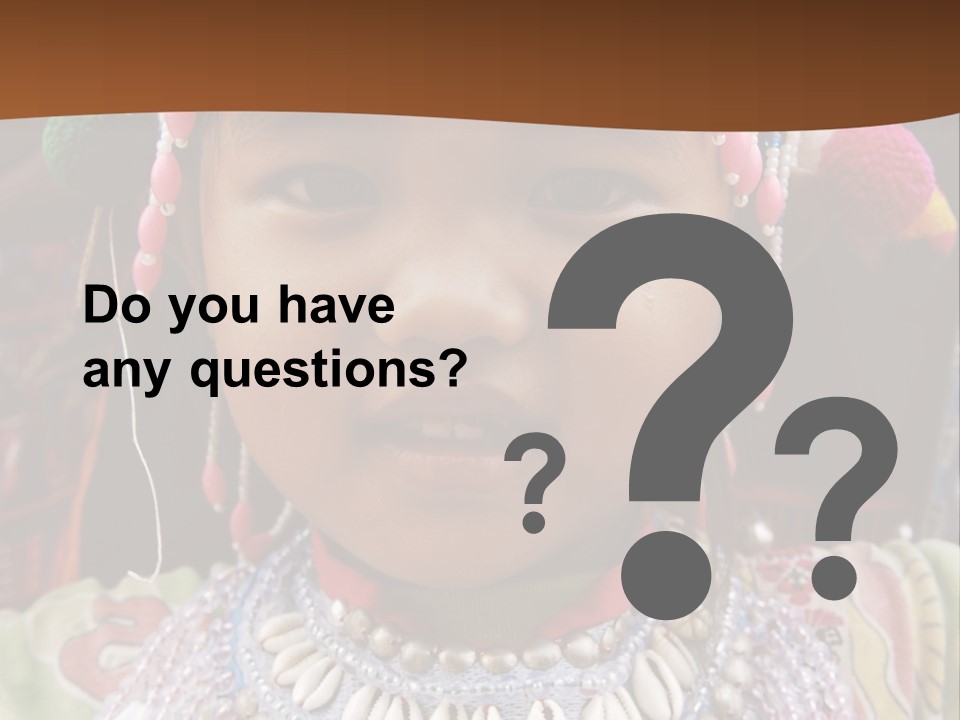 A Young Child Wearing A Headdress Is Smiling For The Camera PowerPoint Template