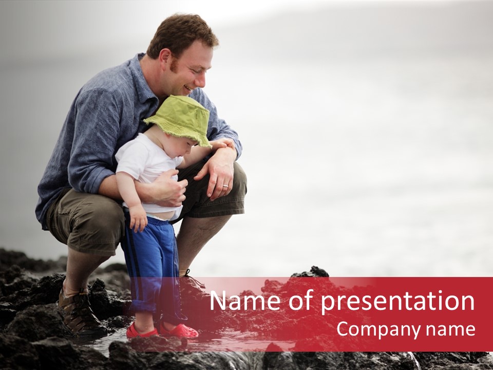 Young Father With Little Son Outdoors At Ocean PowerPoint Template